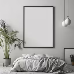 an empty photo frame on the wall above a bed