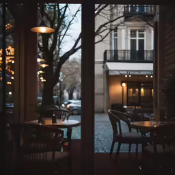 there are chairs and tables in the window of this restaurant