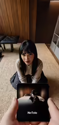 person with tablet displaying advertisement for tablet to use as camera