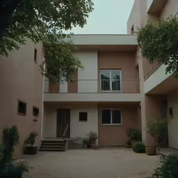 the outside of a building with large trees surrounding