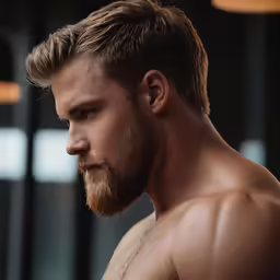 a shirtless man in a gym staring at something
