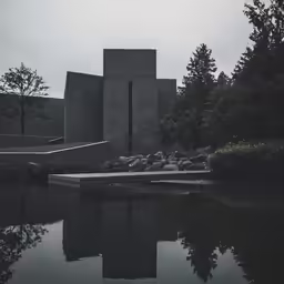 a building is seen sitting on a small lake