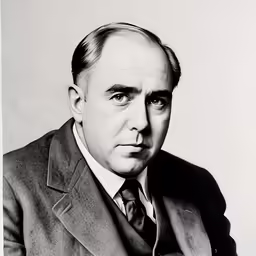 an old picture of a man in a suit and tie