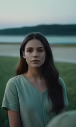 a woman standing in front of water