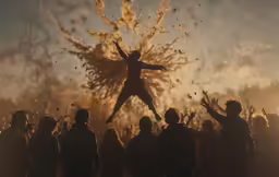 a man leaping through the air surrounded by people