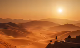 the sun is setting over a mountainous desert area