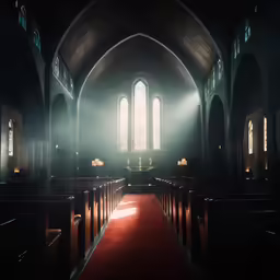 an empty church with red carpeting and pews
