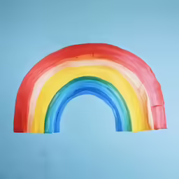 a painting on the side of a rainbow shaped window