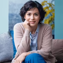 a beautiful woman posing for a picture in her living room
