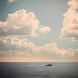 a boat is riding across the large body of water