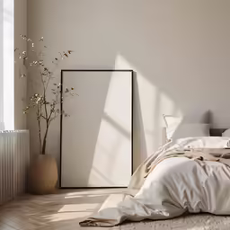 a room with a bed, lamp and a plant