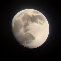 the moon is shining bright in the black sky