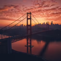 a body of water and the sun behind the bridge