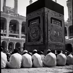 some people are sitting in front of a big clock