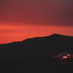 an suv is parked in the middle of the desert