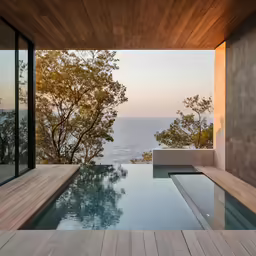 pool with view of lake through the glass door