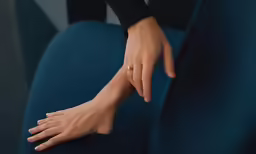 a hand reaching for a piece of something on it