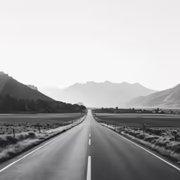 black and white photograph of a deserted road