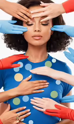 three women in blue gloves putting their hands on top of each other