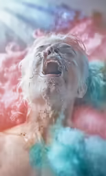a person is laying down with their head covered by foamy water