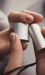 a person holding up two white objects