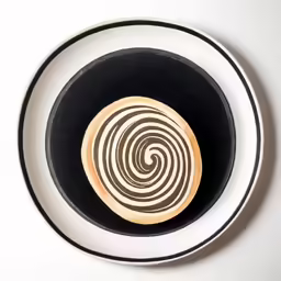 a plate with a swirled design is on a table