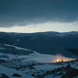 a mountain with trees, rocks and snow