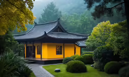 yellow pagoda in chinese garden with lush vegetation