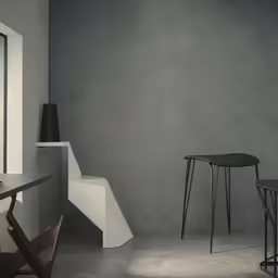 two tables and one chair on cement flooring