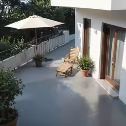 some chairs are by the doors on the back porch