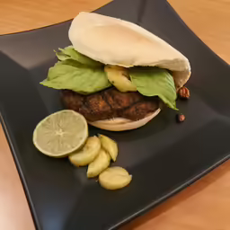 the hamburger has many toppings but the lettuce is also topped with pickles