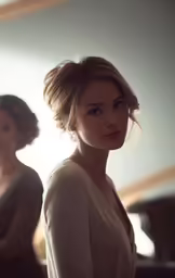 two women are standing in a white room