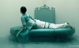 a woman that is laying down on a bed