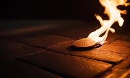 some flames that are being lit on a small object
