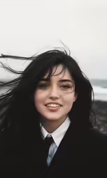 a woman with black hair is standing outside