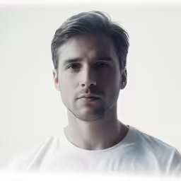 a man is posing for a portrait while wearing white