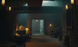 a living room area that is dimly lit and has lots of furniture
