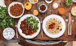 the meal has been prepared and set on the wooden table,a table filled with various plates of food