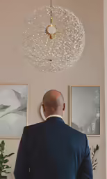 a bald man is facing the wall in his living room