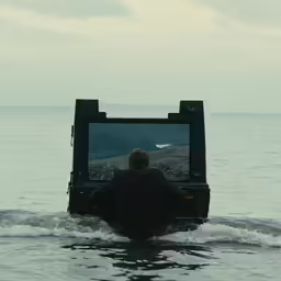 a man sitting in the middle of a lake in front of a tv