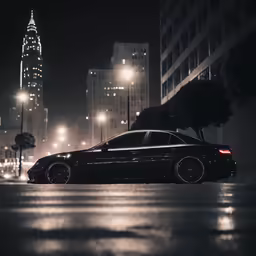 a car parked on the road near tall buildings at night