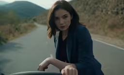a woman on a motorcycle is sitting outside