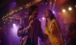 a man and woman sing into a microphone while on stage