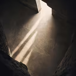 an overhead view of a concrete structure with the sunlight shining in