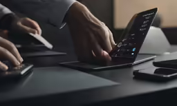 two hands using a mouse while using a lap top