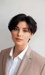 a woman wearing a jacket poses for a headshot