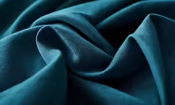 a large teal colored material made from plain fabric