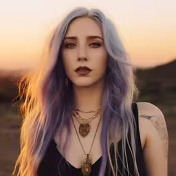 a woman with long, purple hair wearing a necklace,a woman with long purple hair and tattoos wearing gold jewelry