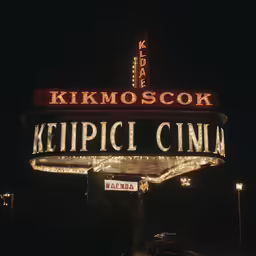 a sign in front of a movie theater
