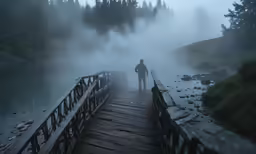a person walking across a foggy bridge